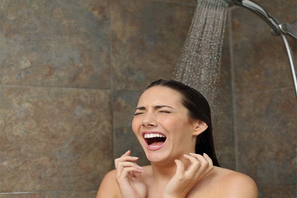 image of a homeowner taking a cold shower depicting water heater failure