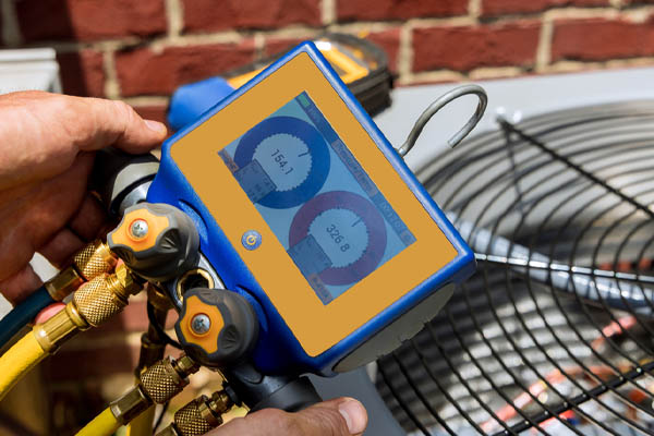 image of hvac contractor measuring refrigerant in an air conditioner