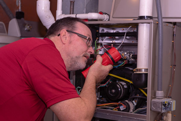 image of an hvac contractor performing furnace repair