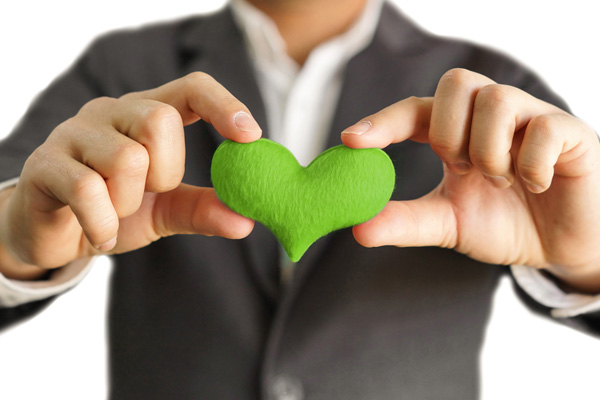 image of hands and plants depicting environmentally friendly fleet fueling services