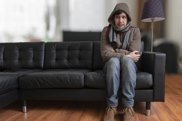 image of homeowner feeling chilly due to boiler breakdown