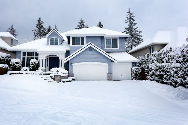 image of house in snow depicting propane storage tank size