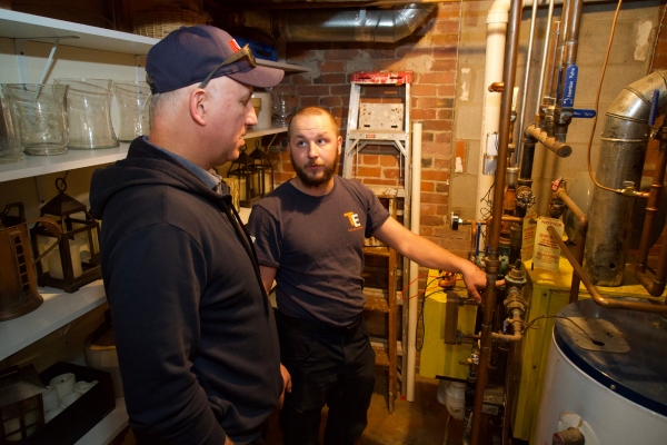 Taylor Energy HVAC technician talking to a client