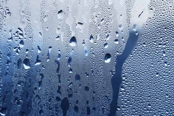 condensation on window depicting oil tank and water
