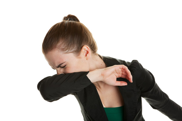 woman sneezing depicting poor indoor air quality