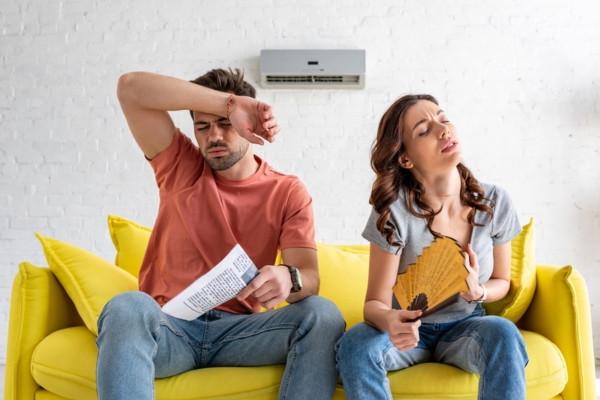 couple sweating a lot due to AC breakdown due to poor maintenance