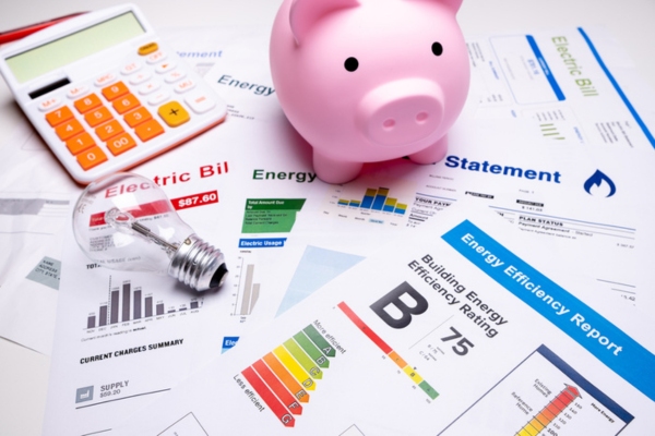 photo of piggy bank on top of utility bills depicting cooling bills savings