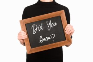 did you know sign written on board held by a woman depicting AC fun facts