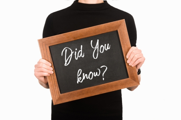 did you know sign written on board held by a woman depicting AC fun facts