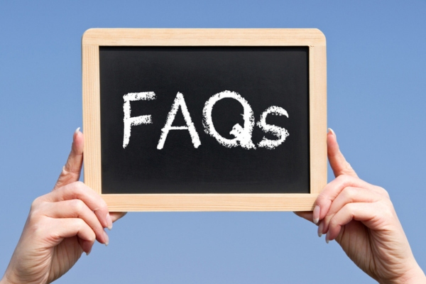 FAQs written on a mini chalkboard depicting questions about Air Conditioner Repair Vs Replace