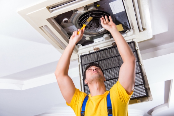 HVAC technician repairing air conditioner