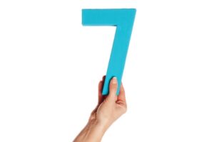 hand holding up the number 7 from the bottom depicting benefits of ductless systems