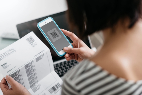 woman looking at electric bill