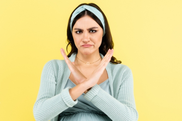 woman showing reject hand gesture depicting avoiding costly HVAC failure