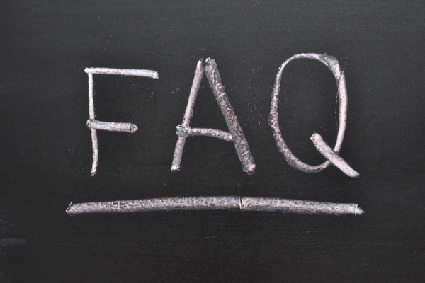 FAQ on chalkboard depicting questions about Ductless Heat Pumps vs Ductless Air Conditioners