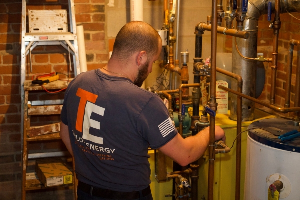 HVAC technician from Taylor Energy servicing a residential boiler