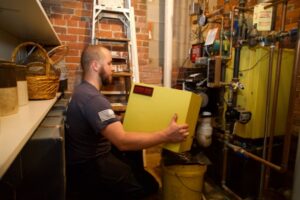 Taylor Energy HVAC technician servicing Energy Kinetics System 2000
