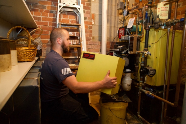 Taylor Energy HVAC technician servicing Energy Kinetics System 2000