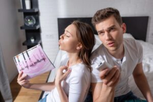 couple feeling warm and humid indoors depicting air conditioner not removing humidity