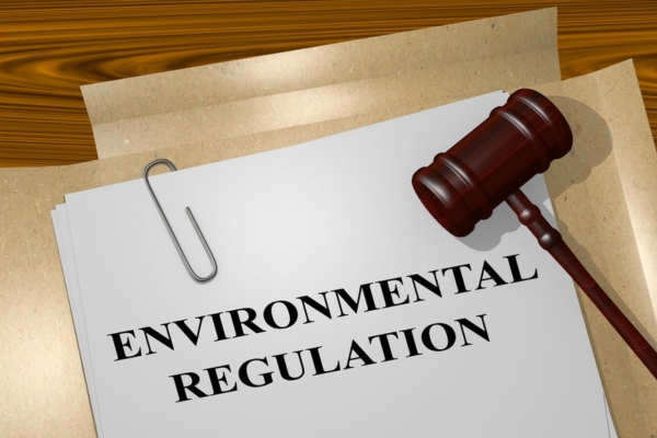 environmental regulation on paper beside a gavel depicting propane storage