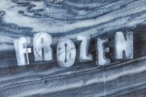 frozen word spelled using letter ice cubes depicting frozen air conditioner