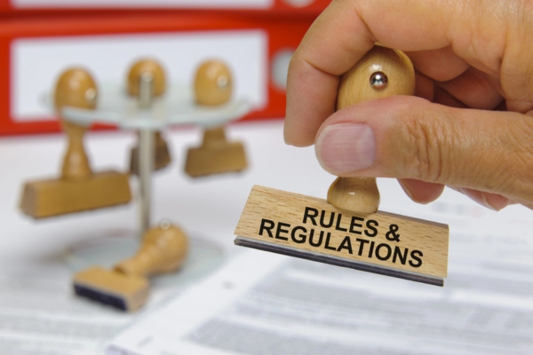 hand holding a stamp that says rules and regulation depicting Painting Propane Storage Tanks