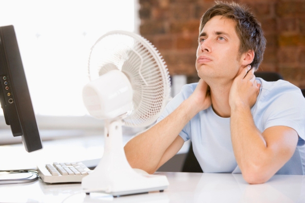 man feeling warm at home office due to AC not keeping up