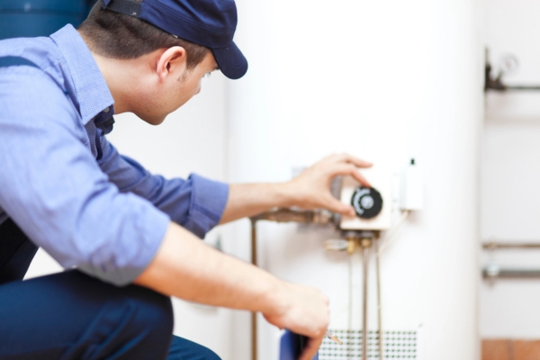 plumber flushing the water heater