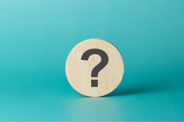 question mark on a round wooden chip depicting FAQs about ac not keeping up