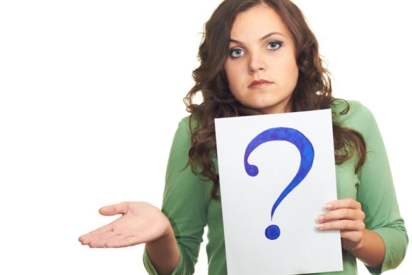 woman holding a card with a question mark depicting FAQs about Water Heater Life expectancy