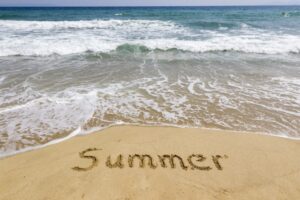 Word summer written in sand on the beach