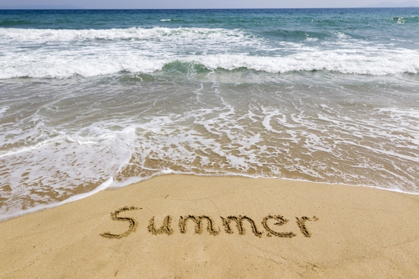 Word summer written in sand on the beach