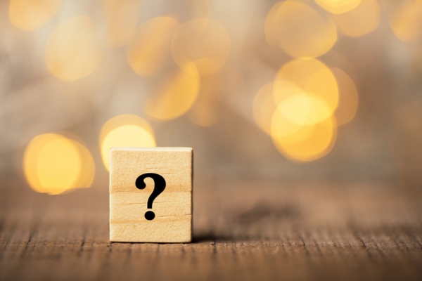 question mark on a wooden chip depicting FAQs about HVAC Air Filter Replacement