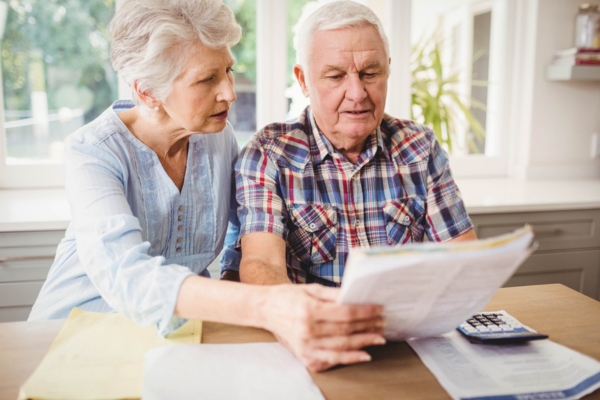 senior couple looking at increased energy bills