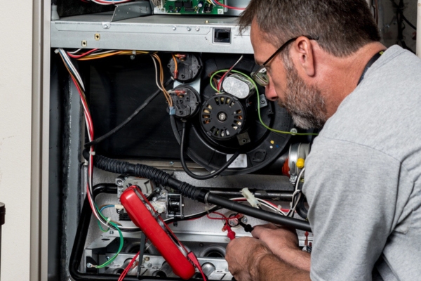 HVAC technician performing furnace tune-up