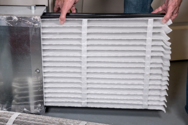 homeowner changing home furnace filter