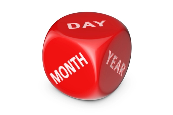 red dice that says month day year on different sides depicting How Long Should a Garbage Disposal Last