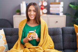 woman feeling cozy and warm indoors during winter