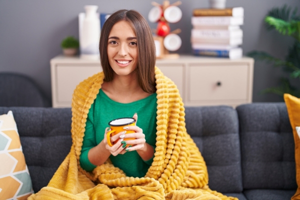 woman feeling cozy and warm indoors during winter