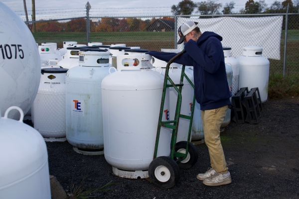 Taylor Energy propane delivery staff moving propane tanks
