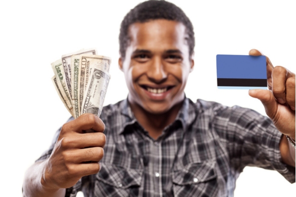 man holding cash and card on each hand