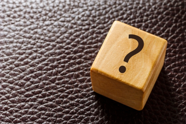 question mark on a wooden cube on top of a leather surface depicting Fuel Oil Company FAQs