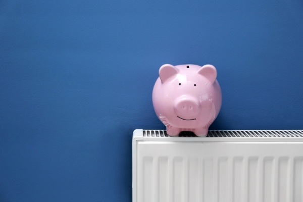 piggy bank on top of home heating radiator