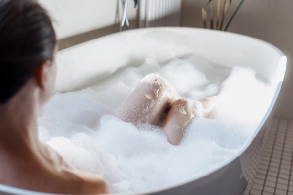 woman in a bathtub full of foam and hot water