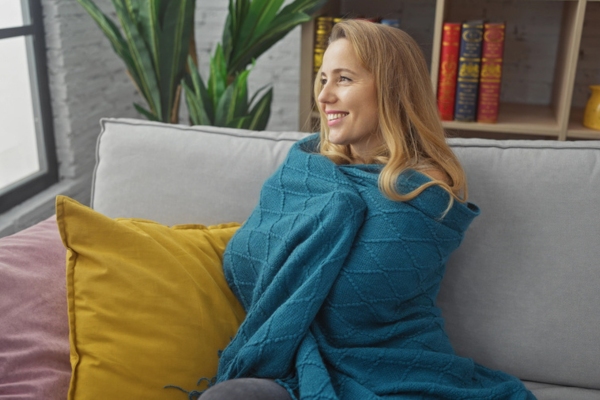 woman relaxing on the couch and staying warm