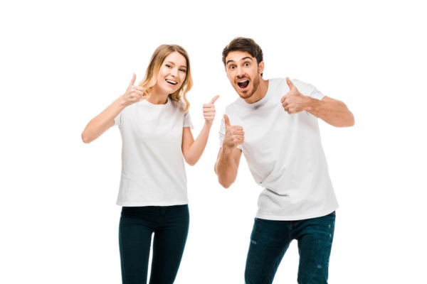 Happy young couple showing thumbs up and smiling depicting improved HVAC efficiency