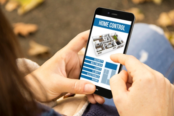 Woman using home control app on her mobile phone
