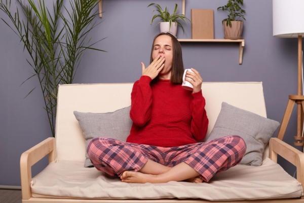 woman feeling cozy from heating and cooling central HVAC system