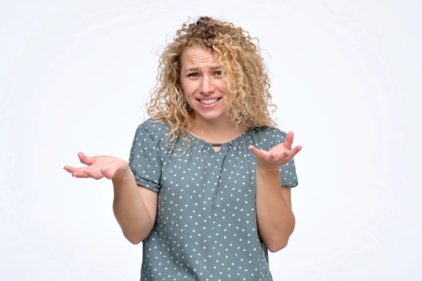 woman shrugging while asking How Do New Air Conditioning Systems Compare to Older Models in Efficiency