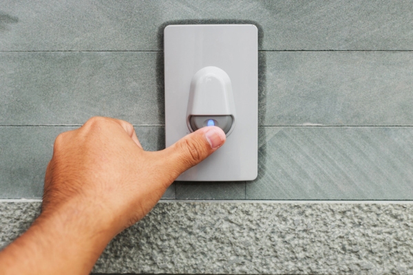 hand pressing doorbell depicting Door-to-Door Sales Tactics